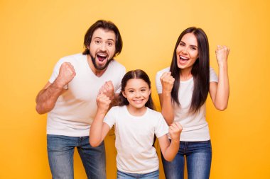 Portrait of nice lovely attractive charming cheerful cheery glad people mom dad pre-teen girl showing winning gesture yes breakthrough isolated over shine vivid pastel yellow background clipart