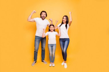 Full length body size view portrait of nice attractive charming cheerful optimistic people mom dad pre-teen girl showing winning gesture yes isolated over shine vivid pastel yellow background clipart