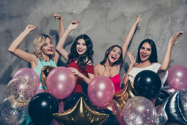 Portrait of nice-looking lovely chic attractive glamorous shine gorgeous cheerful ladies many different baloons festive raising hands up over gray concrete wall — Stock Photo, Image