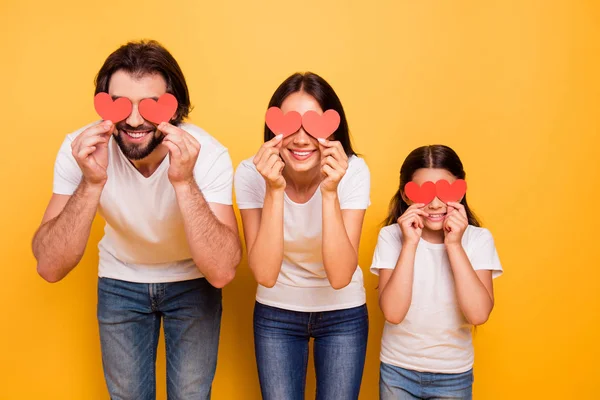 Portrait of nice cute attractive funny cheerful cheery people closing covering eyes with red paper cards isolated over shine vivid pastel yellow background — Stock Photo, Image