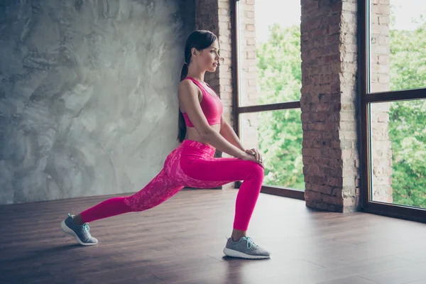 Profile side view of nice strong beautiful attractive graceful thin sportive lady doing one leg situps in modern loft industrial interior style indoors — Stock Photo, Image