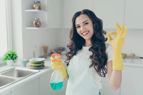 Close up photo beautiful busy nice duties she her lady house hold okey symbol washing supplies pulverize promo housemaid wear jeans denim casual t-shirt covered by cute apron bright light kitchen — Stock Photo, Image