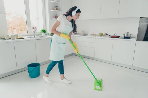 Full length body size portrait of her she nice beautiful cheerful cheery wavy-haired house-wife cleansing shine floor listening podcast in modern light white interior indoors — Stock Photo, Image