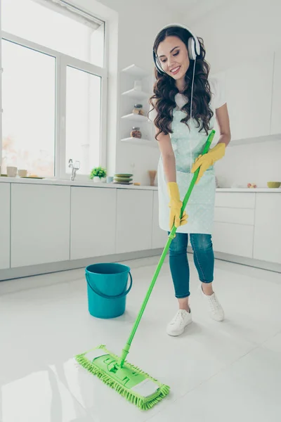 Vertical full length body size portrait of her she nice sweet beautiful cheerful wavy-haired house-wife cleansing polishing shine floor listening podcast in modern light white interior indoors — Stock Photo, Image