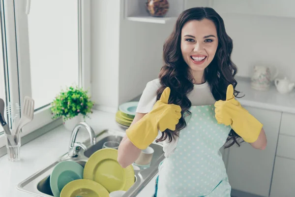 Portrait of her she nice cute adorable charming lovely attractive beautiful cheerful wavy-haired house-wife showing two double thumbup in yellow gloves in modern light white interior — Stock Photo, Image