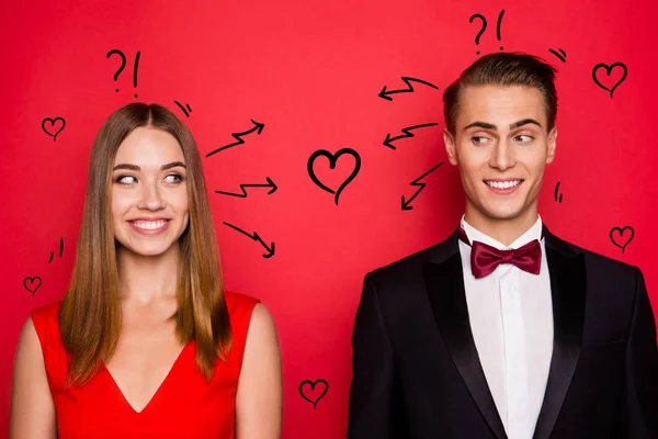 Closr-up portrait of two nice chic lovely attractive imposing cheerful funny flirty people wearing dress and bow tux looking at each other thinking isolated over bright vivid shine red background — Stock Photo, Image