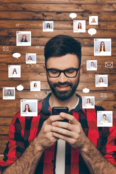 Portrait cheerful smiling he him his young guy chatting smart phone addicted online sit internet illustration pictures girls dating site futuristic design isolated wooden background — Stock Photo, Image