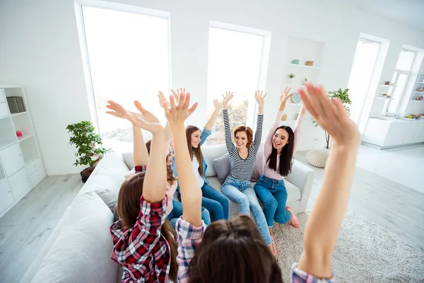 Close up top above high angle view photo beautiful she her ladies family roommates hold arms raised up play against boys guys got great win excited amazed sit cozy sofa room girls day indoors — стоковое фото
