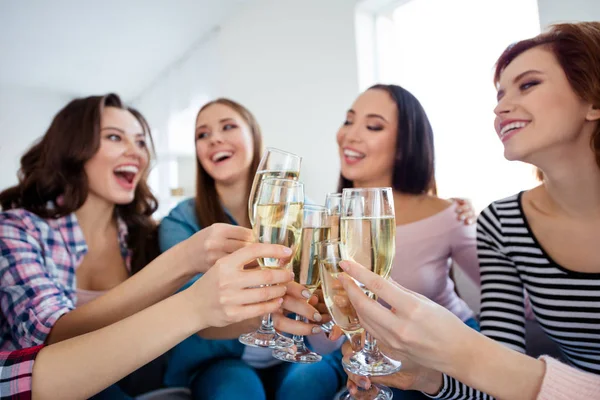 Portrait of nice-looking cute lovely charming attractive cheerful cheery ladies clinking wine wineglass sparkles great event greetings in light white interior room indoors — Stock Photo, Image