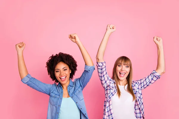 De cerca foto dos diversidad ella sus señoras diferentes piel de la raza gritar brazos manos levantadas increíble triunfo suerte usar casual jeans vaquero a cuadros camisa ropa traje aislado rosa fondo —  Fotos de Stock