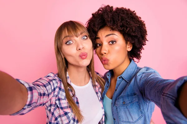 Close up photo two funny diversity she her ladies playful make take selfies send air kisses coquette buddies wear casual jeans denim checkered shirt clothes outfit isolated pink background — Stock Photo, Image