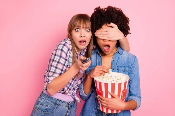Portrait of two person nice cute lovely attractive charming scared funny girls in checkered shirt switching channels closing covering eyes isolated over pink pastel background — Stock Photo, Image
