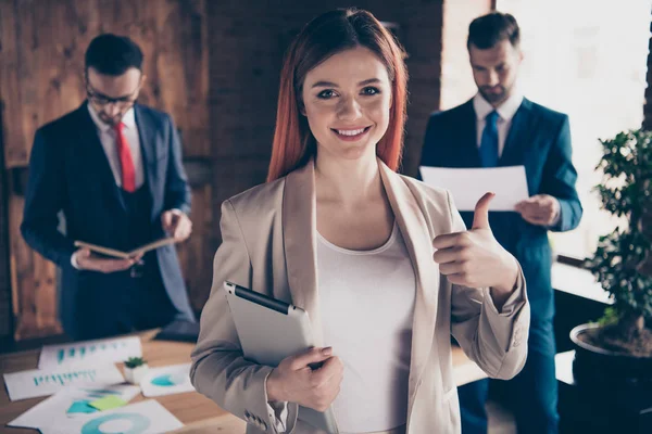 Close up photo three people she her business lady recommend new development courses hold thumb up e-book deal done great he he he his guys stand office table wearing formal wear suit —  Fotos de Stock