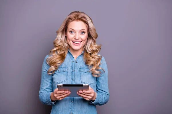 Portrait of her she nice cute lovely fascinating charming attractive cheerful cheery wavy-haired lady wearing blue shirt holding in hands tablet speed isolated over gray pastel background — Stock Photo, Image