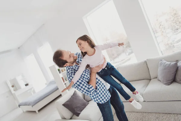 Portrait of nice cute adorable lovely attractive cheerful cheery glad funny pre-teen girl handsome dad daddy having fun flying daydream dream morning in light white interior room indoors — Stock Photo, Image