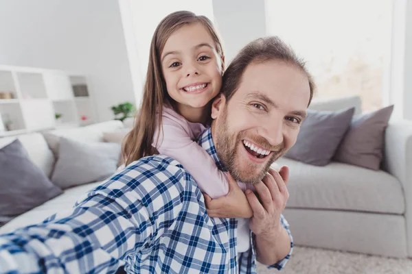 Self-portrait of nice lovely attractive cheerful cheery funny glad excited pre-teen girl handsome trendy dad daddy cuddling daydream dream vacation in modern light white interior room indoors — Stock Photo, Image