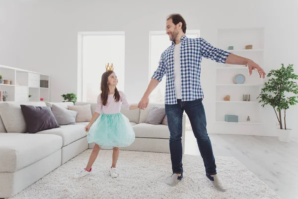 Full length body size portrait of nice lovely attractive cheerful cheery positive pre-teen girl handsome dad daddy holding hands dancing dream holiday in modern light white interior room indoors — Stock Photo, Image