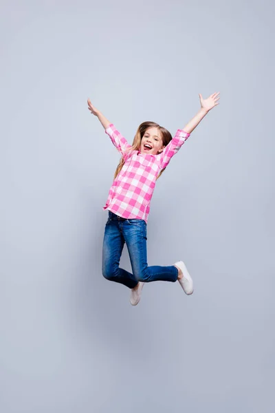 Full length body size vertical photo blond haired she her little cheerleader laugh laughter jump high achievement wear casual jeans pink plaid checkered shirt outfit clothes isolated grey background — Stock Photo, Image