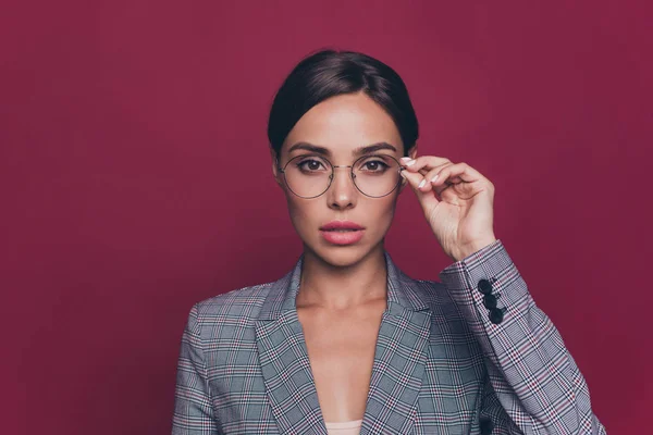 Close up photo amazing attractive active profession she her lady hold one hand arm specs look seriously camera just started career entrepreneur wearing formal-wear isolated dark red vivid background