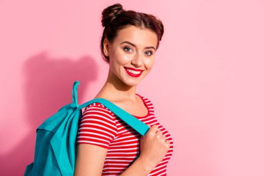 Close-up portrait of her she nice-looking cute charming attractive glamorous cheerful teen girl wearing striped t-shirt blue bag bachelor master degree isolated over pink pastel background clipart