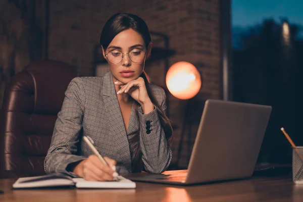 Close up photo beautiful she her business lady chief got promotion work day night first startup get some mistakes moments write down sit big office chair wear specs formal wear checkered plaid suit — Stock Photo, Image