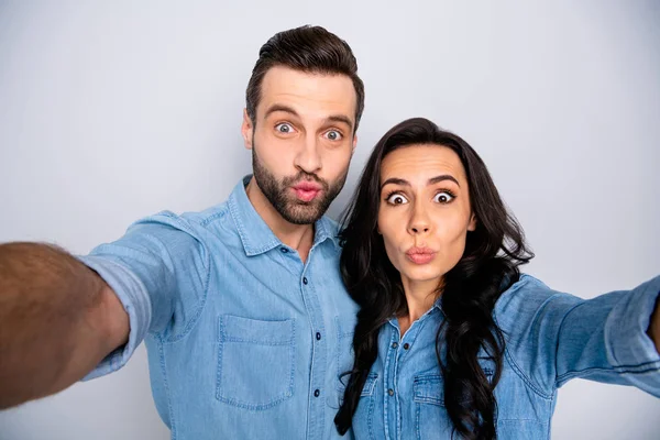 Close up portrait funky amazing she he he he his lady guy pretty childish couple make take selfies facial expression wear casual jeans denim shirts outfit clothes isolated light grey background —  Fotos de Stock