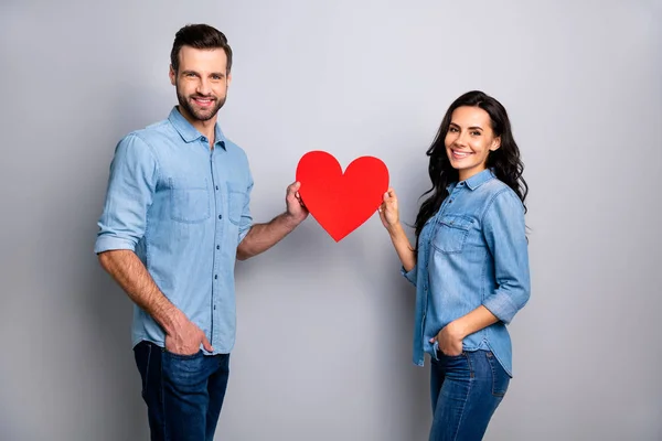 Portrait of cute beautiful spouses people enjoying trusting respecting holding huge valentine paper card satisfied positive wearing denim blue outfit isolated on ashy-gray background — Stock Photo, Image