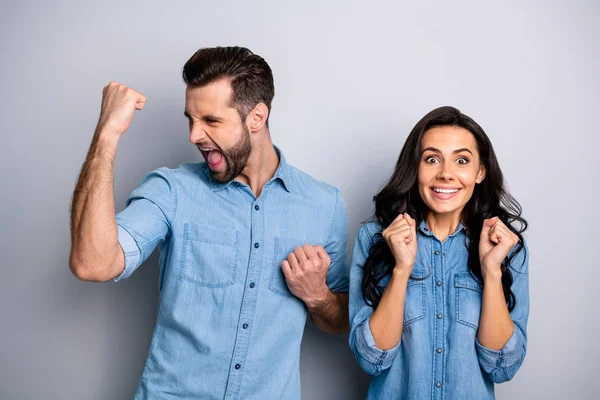Portrait of cheerful funny impressed hipsters fellows heard incredible unbelievable news information about achievements isolated wearing blue denim clothes over silver background — Stock Photo, Image