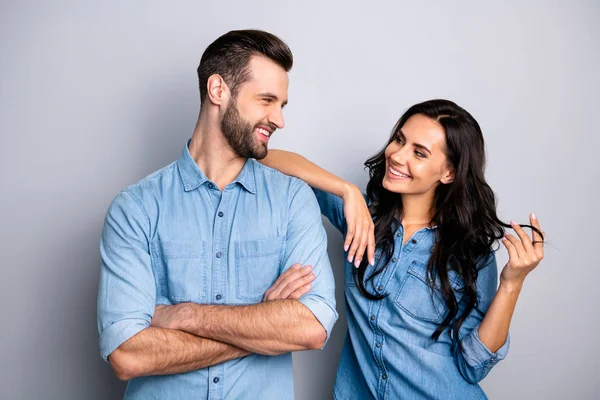Portrait of cute pleasant adorable guy lady trying to go on date touching shoulder curls by hand fingers looking tender gentle wearing denim outfit on argent background — Stock Photo, Image