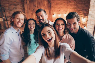 Self-portrait of nice attractive lovely charming winsome cheerful cheery glad ecstatic positive ladies gentlemen having fun embracing house event dream in industrial loft interior room indoors clipart