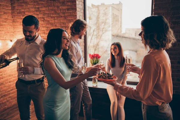 Company of nice-looking elegant classy attractive pretty cheerful guys ladies having fun talk 8 March day spring romantic atmosphere buffet snack in industrial loft interior room indoors — Stock Photo, Image