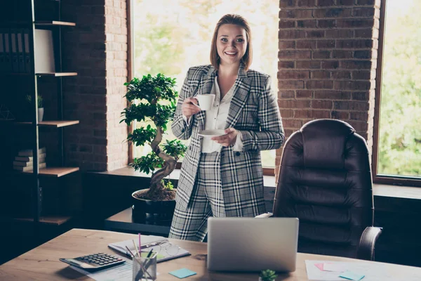 Gros plan photo belle incroyable elle son entreprise dame tenir tasse en verre blanc regard gai boisson chaude invités invitent viennent dans la table portable assis bureau portant les spécifications formalwear à carreaux costume à carreaux — Photo