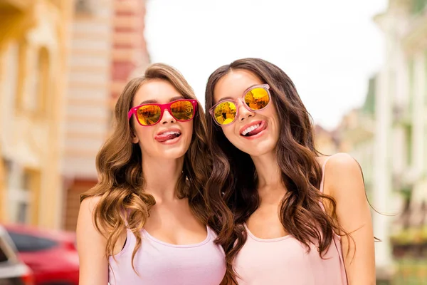 Close up photo cute nice pretty careless fellowship students funny enjoy comic humor joke trip long hair stroll carefree time travel colorful specs pink clothing spring town center — стоковое фото