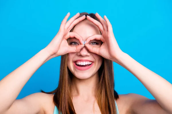 Close up photo of lovely cute trendy college student advertising people recommending deciding fooling free time making eyewear with fingers feeling excited on bright background — ストック写真