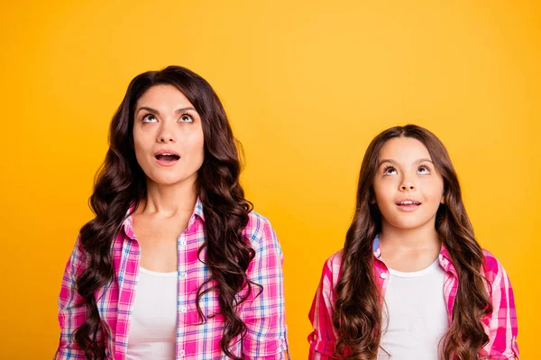 Portrait of cute astonished mature little ladies charming impressed by incredible thing looking up opened mouth dressed in colorful modern outfit isolated on vibrant background