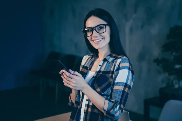 Close-up portrait of her she nice cute lovely attractive charming cheerful cheery brunette lady wearing checked shirt holding in hands device gadget industrial loft style interior work place station — 스톡 사진