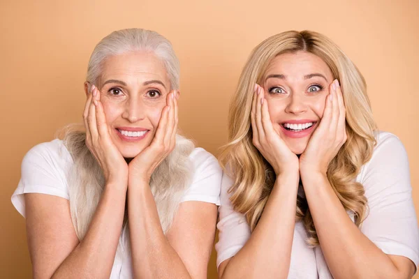 Close-up portrait of nice-looking winsome lovely attractive charming cheerful cheery ladies wearing white t-shirt showing delight expression isolated over beige pastel background — Stock Photo, Image