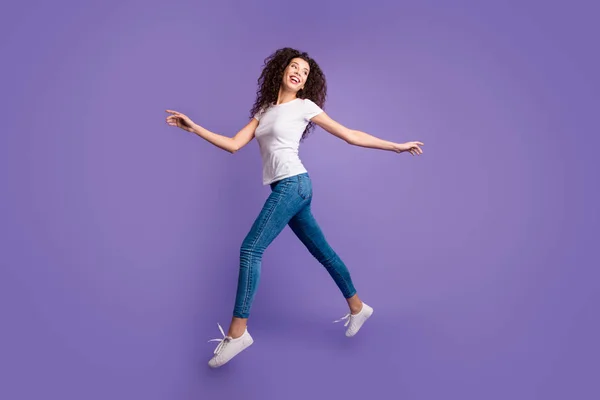 Full length side profile body size photo funky beautiful she her lady jump high spread hands arms shopping store mall wear casual jeans denim white t-shirt sneakers isolated purple violet background — Stock Photo, Image