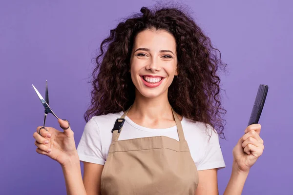 Close up foto bella lei lei signora tenere le mani taglio di capelli attrezzature sinceramente dentato sorridente clienti clienti indossano casual bianco t-shirt grembiule isolato viola sfondo viola — Foto Stock