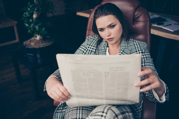 Close up photo amazing beautiful she her business busy lady hold arms hands newspaper look wondered marketing article sit big large office cozy chair wear formal-wear checkered plaid suit — Stock Photo, Image