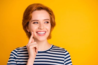 Close-up portrait of her she nice-looking lovely pretty charming attractive cheerful cheery girl touching cheek looking aside isolated over bright vivid shine yellow background clipart