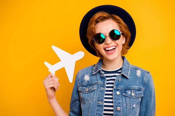 Close up photo beautiful amazing she her lady hand arm little small airplane traveler wear specs vintage hat casual striped t-shirt jacket jeans denim outfit isolated yellow bright vivid background — Stock Photo, Image