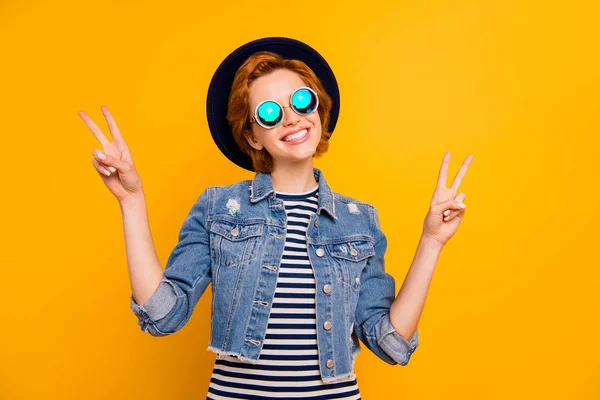 Close up photo beautiful she her lady arm hand traveler perfect modern look show v-sign say hi wear specs vintage hat casual striped t-shirt jacket jeans isolated yellow bright vivid background — стоковое фото