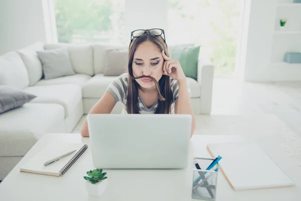 Close up photo beautiful she her her lady notebook table funky mood not working make false moustache search tv show wear jeans denim striped t-shirt sit comfort chair house bright living room indoors — Foto de Stock