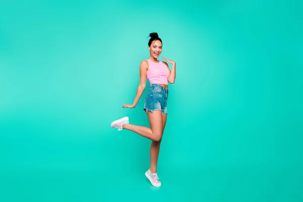 Full length side profile body size photo beautiful she her lady stylish hairstyle have walk park weekend wear casual pink tank-top jeans denim shorts outfit clothes isolated teal turquoise background — Stock Photo, Image