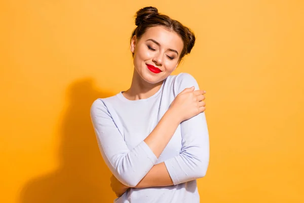 Portrait of her she nice attractive lovely peaceful calm winsome adorable cheerful girl hugging herself warmth closed eyes isolated over bright vivid shine yellow background — Stock Photo, Image