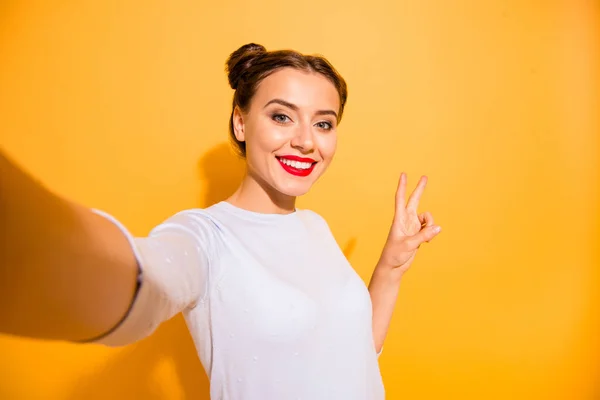 Portret uroczy dziewczęcy funky Hipster student stwarzające co selfie v-znak udostępnianie zdjęć delegowania na jej konto sieci społecznej ubrany w białą bawełnianą Odzież na białym tle na żywe — Zdjęcie stockowe