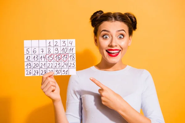 Close up photo funky beautiful she her lady pretty hairdo two buns hand arm hold paper calendar admit close days off amazed glad wear casual white pullover clothes isolated yellow background — Stock Photo, Image