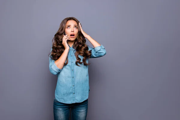 Close up photo amazing beautiful her she lady hold arms hands phone head look up empty space unexpected epic fail failure oh no wearing casual jeans denim shirt clothes isolated grey background — Foto de Stock