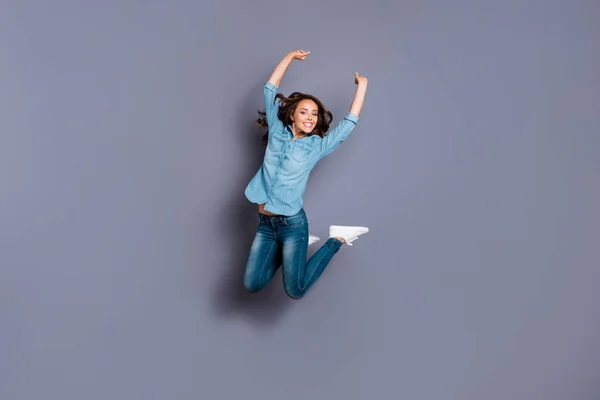 Фотография в полный рост поражает своей красотой, она леди прыгает высокий чирлидер рад баскетбольный бейсбольный футбольный матч болельщик в случайных джинсах джинсы джинсы рубашка изолированный серый фон — стоковое фото